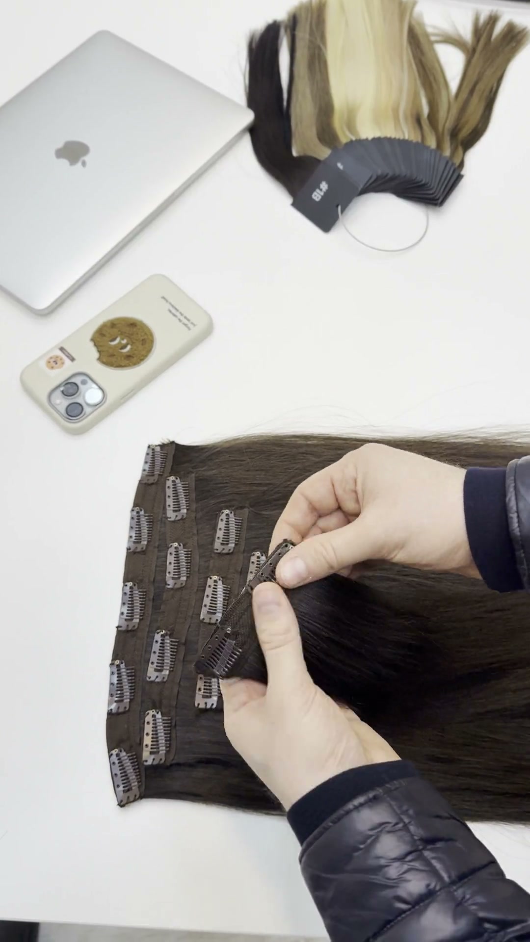Hands checking a clip-in fastening beside shade swatches.